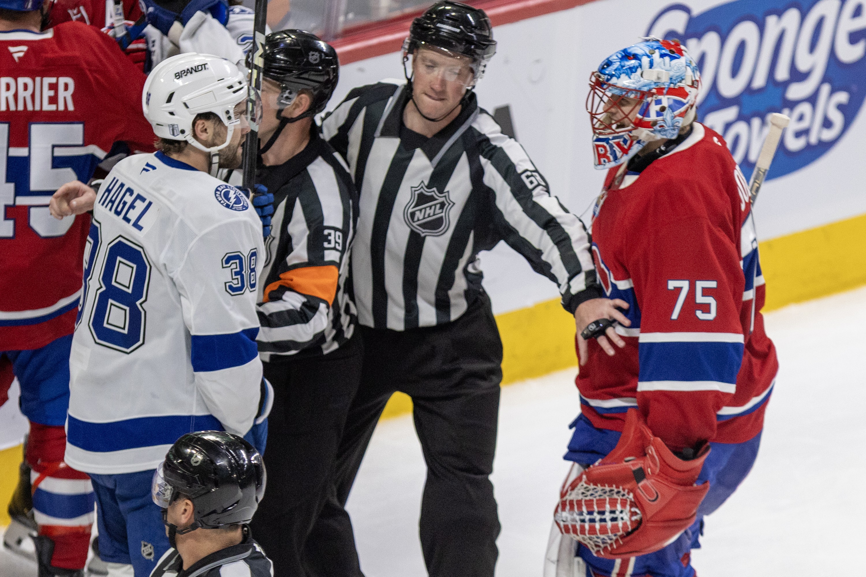 Montreal Canadiens' Jakub Dobes has words with Tampa Bay Lightning's Brandon Hagel.