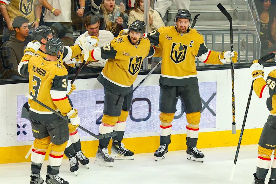 Vegas Golden Knights D Shea Theodore (27) celebrates with his teammates after scoring a goal against the Vancouver Canucks on Monday, March 30, 2026, in Las Vegas, Nevada.