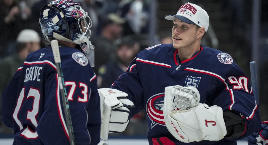 Nov 1, 2025; Columbus, Ohio, USA; Columbus Blue Jackets goaltender Jet Greaves (73) celebrates with goaltender Elvis Merzlikins (90) after defeating the St. Louis Blues at Nationwide Arena.