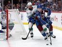 Nathan MacKinnon of the Colorado Avalanche gets a step on Vancouver Canucks defenceman Filip Hronek in second period of Dec.2, 2025 game at Denver.