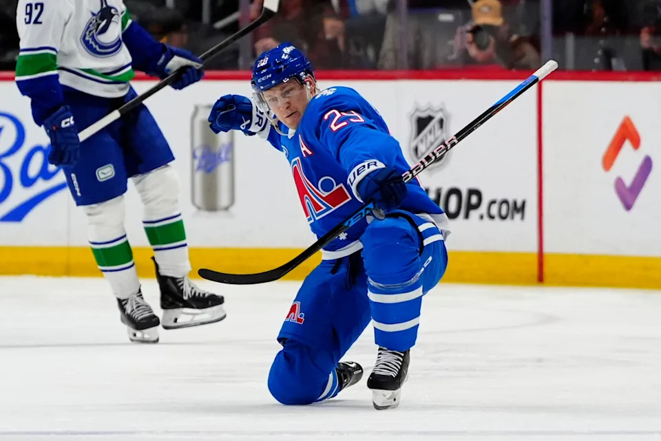 Colorado Avalanche center Nathan MacKinnon (29) celebrates his fiftieth goal of the season during the first period against the Vancouver Canucks at Ball Arena.Ron Chenoy-Imagn Images