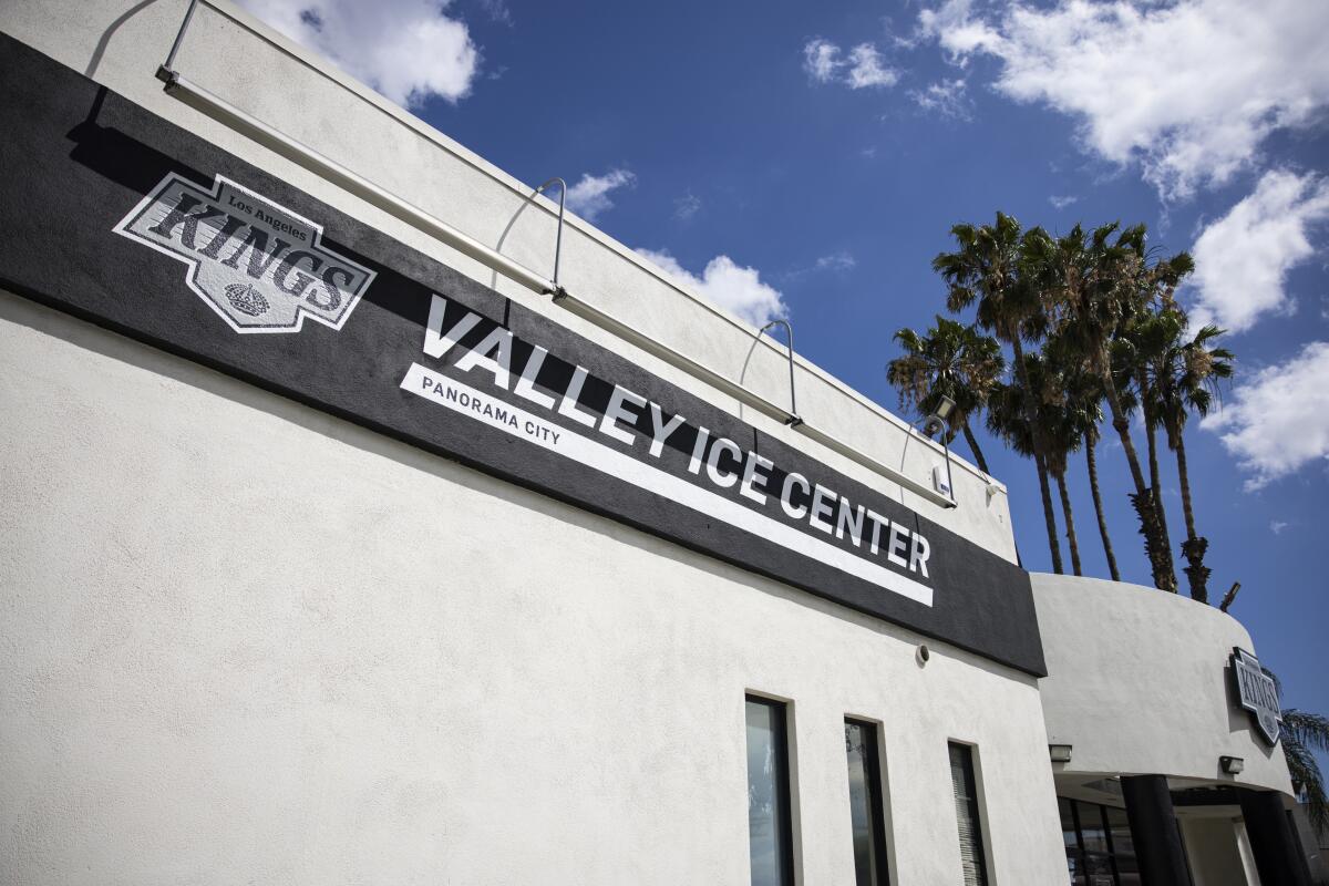 The entrance to a building has a black and white sign that says Valley Ice Center.
