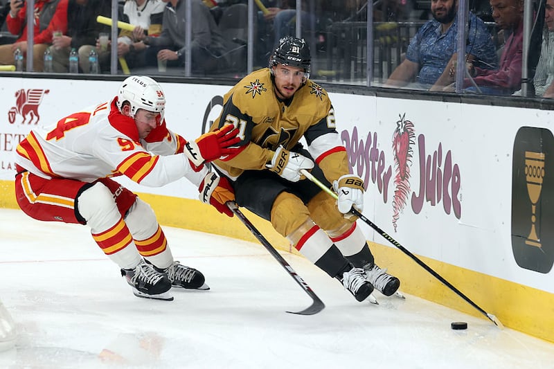 Brett Howden #21 of the Vegas Golden Knights skates against Brayden Pachal #94 of the Calgary Flames during the first period at T-Mobile Arena