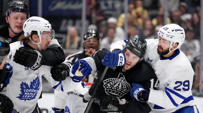 Los Angeles Kings center Samuel Helenius, left, and Toronto Maple...