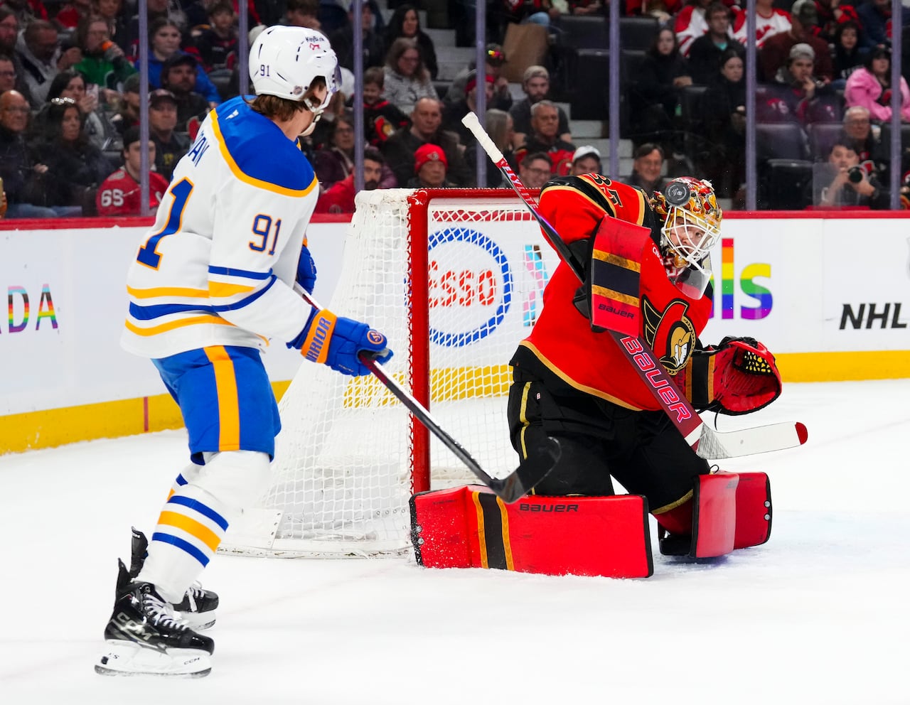 Senators goaltender makes a save.