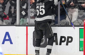 Los Angeles Kings right wing Quinton Byfield, top, celebrates after scoring the game-winning goal as Toronto Maple Leafs goaltender Joseph Woll lays on the ice during overtime of an NHL hockey game Saturday, April 4, 2026, in Los Angeles. (AP Photo/Mark J. Terrill)