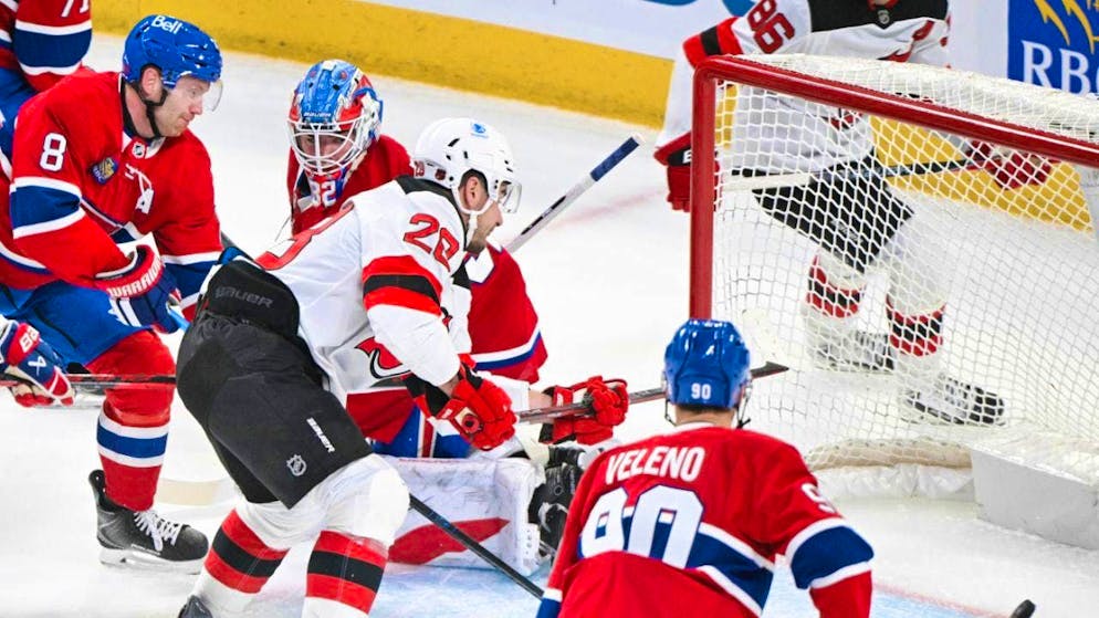 Timo Meier (in white) scores the 1-0 goal in the Devils' 3-0 win over the Canadiens in Montreal