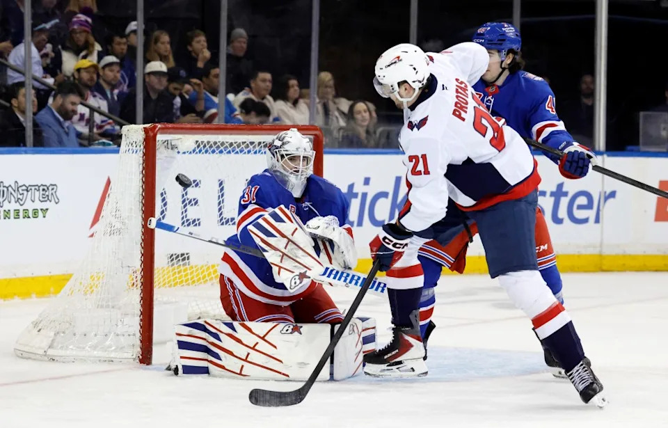 New York Rangers goaltender Igor Shesterkin (L) makes a save on a tipped shot by Washington Capitals left wing Aliaksei Protas (C) in the second period at Madison Square Garden in New York, USA, Sunday, April 05, 2026. JASON SZENES FOR THE NEW YORK POST