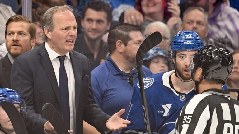 Tampa Bay Lightning head coach Jon Cooper talks with linesman...