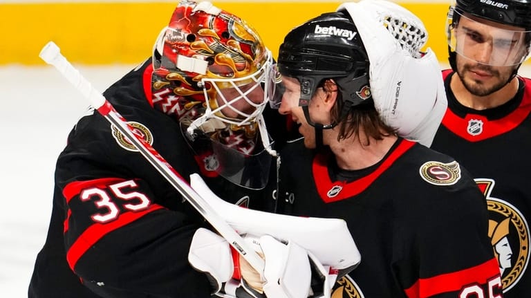 Ottawa Senators goaltender Linus Ullmark (35) and teammate Jake Sanderson...
