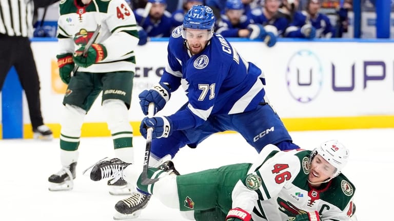 Minnesota Wild defenseman Jared Spurgeon (46) falls down as he...