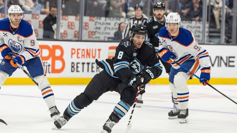 Utah Mammoth center Nick Schmaltz (8) moves the puck on...
