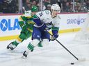 Zeev Buium skates with the puck ahead of Minnesota Wild left wing Matt Boldy during the first period of the game on Thursday, April 2, 2026.
