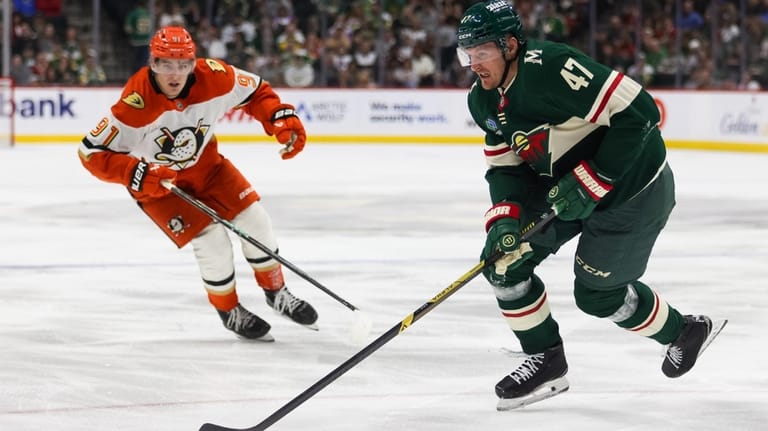 Minnesota Wild's Michael McCarron (47) controls the puck ahead of...