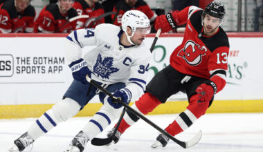 FILE - Toronto Maple Leafs center Auston Matthews (34) controls the puck past New Jersey Devils center Nico Hischier (13) during the second period of an NHL hockey game, March 4, 2026, in Newark, N.J. (AP Photo/Adam Hunger, File)