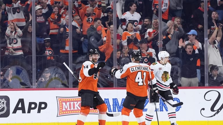 Philadelphia Flyers' Sean Couturier (14) and Luke Glendening (41) celebrate...