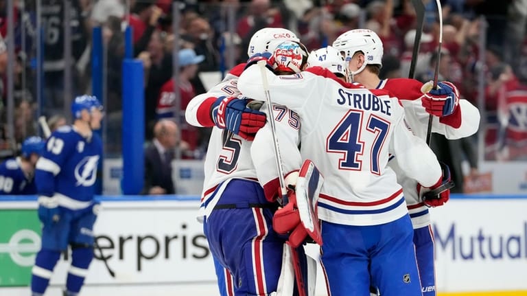 Montréal Canadiens goaltender Jakub Dobes (75) celebrates with defenseman Jayden...