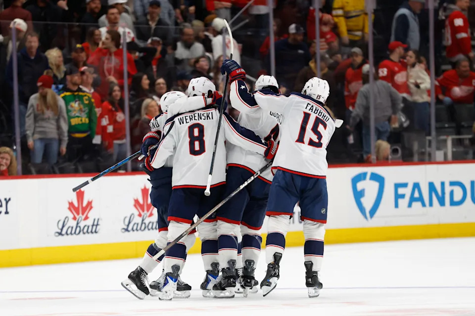 Apr 7, 2026; Detroit, Michigan, USA; Columbus Blue Jackets center Charlie Coyle (3) receives congratulations from teammates after he score on Detroit Red Wings goaltender John Gibson (36) during shoot out to win the game against the Detroit Red Wings at Little Caesars Arena. Mandatory Credit: Rick Osentoski-Imagn Images