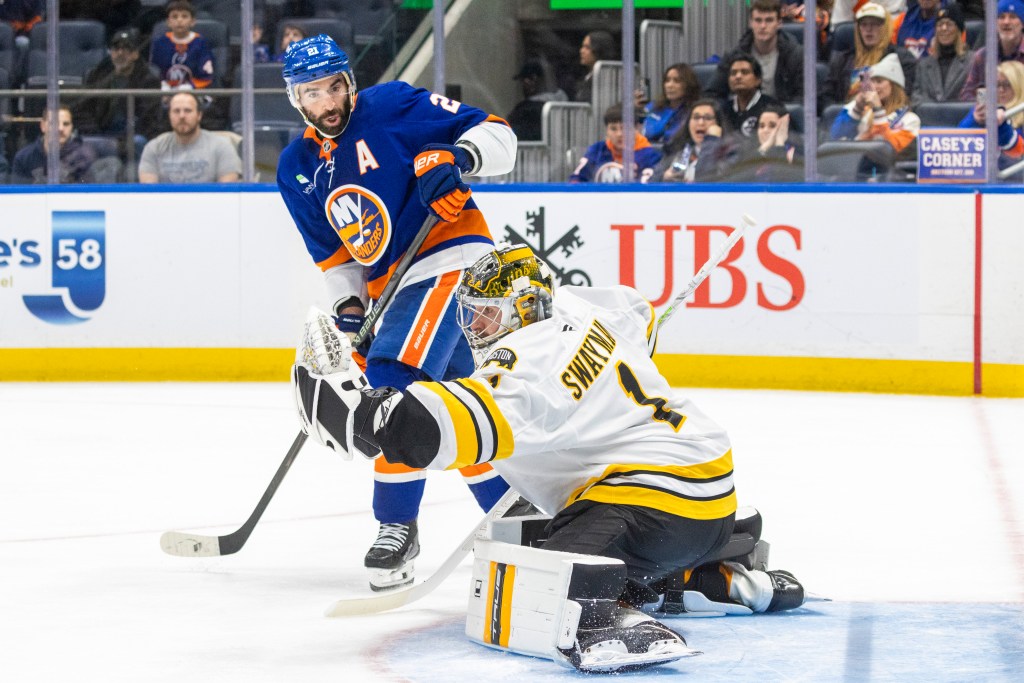 Kyle Palmieri #21 of the New York Islanders watches as Jeremy Swayman #1 of the Boston Bruins makes a glove save during the third period at UBS Arena, Wednesday, Nov. 26, 2025, in Elmont, NY.