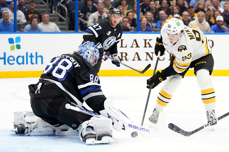 Tampa Bay Lightning goaltender Andrei Vasilevskiy (88) stops a shot by Boston Bruins center Fraser Minten (93) stops a shot by during the first period of an NHL hockey game Saturday, April 4, 2026, in Tampa, Fla. (AP Photo/Chris O'Meara)