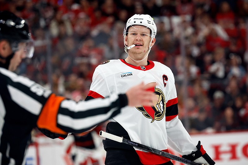Ottawa Senators' Brady Tkachuk, right, protests a call with an official during the second period of an Game 1 of an NHL hockey Stanley Cup first-round playoff series against the Carolina Hurricanes in Raleigh, N.C., Saturday, April 18, 2026. (AP Photo/Karl DeBlaker)
