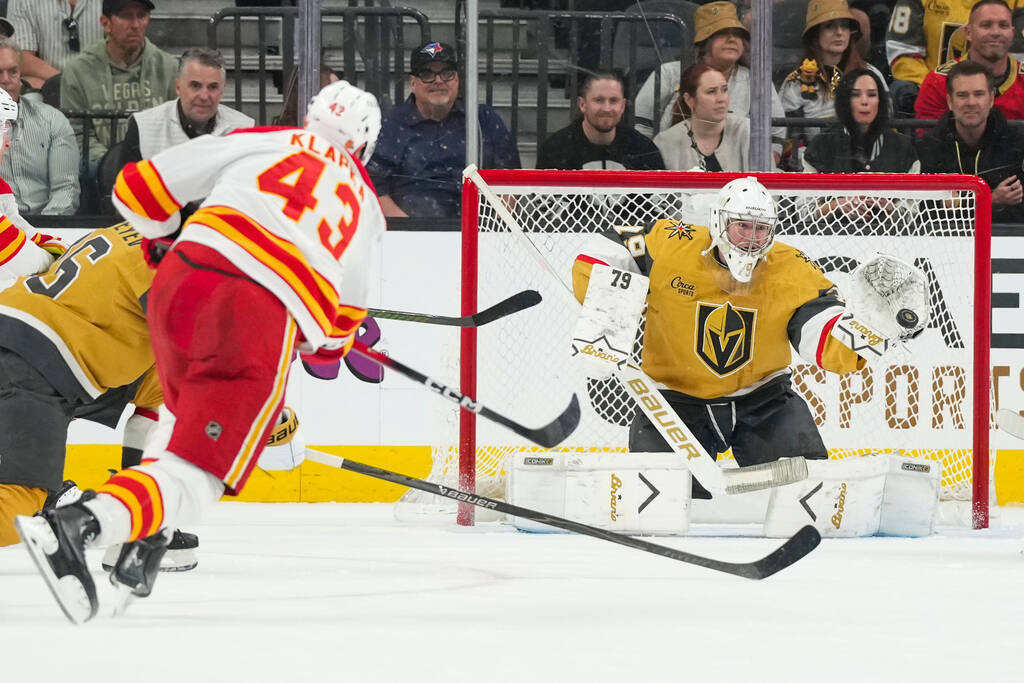 Vegas Golden Knights goaltender Carter Hart (79) stops a shot from Calgary Flames right wing Ad ...