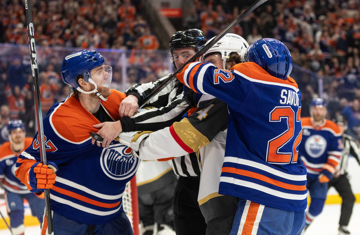 Vegas Golden Knights' Rasmus Andersson (4) roughs it up with Edmonton Oilers' Connor ...