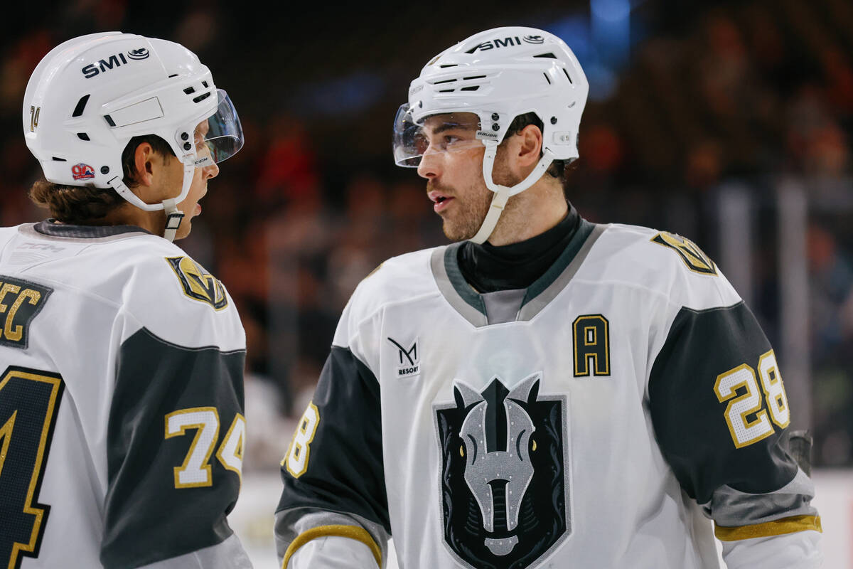 Silver Knights forward Tanner Laczynski (28) confers with Silver Knights defenseman Viliam Kmec ...