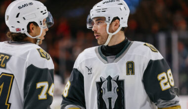 Silver Knights forward Tanner Laczynski (28) confers with Silver Knights defenseman Viliam Kmec ...