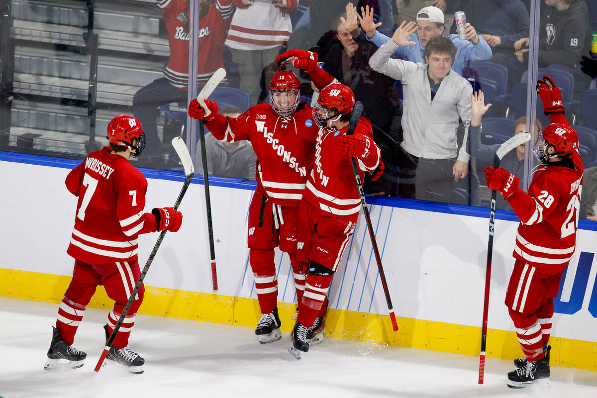 Wisconsin forward Christian Fitzgerald (13) celebrates with teammates after scoring a goal duri ...