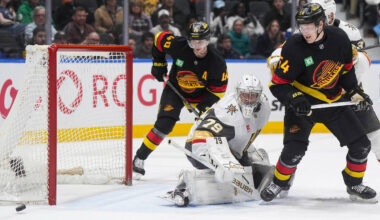 Vegas Golden Knights goalie Carter Hart (79) and Vancouver Canucks' Aatu Raty (54) and Eli ...