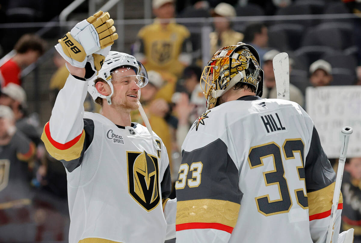 Vegas Golden Knights center Jack Eichel (9) celebrates with goaltender Adin Hill (33) after the ...