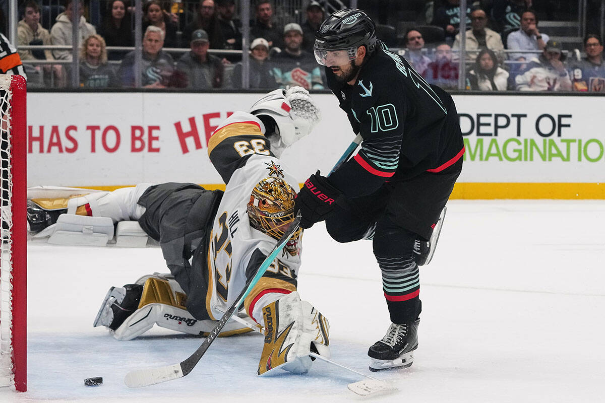 Seattle Kraken center Matty Beniers scores past Vegas Golden Knights goaltender Adin Hill (33) ...