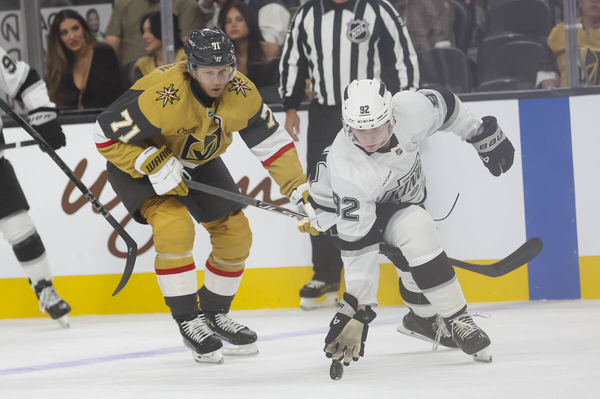 Los Angeles Kings defenseman Brandt Clarke (92) reaches out to tap the puck after losing his st ...