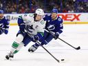 Former Vancouver Canucks captain Quinn Hughes wheels away from Lightning forward Yanni Gourde during second period at Tampa Bay, Fla. on Nov.16, 2025.