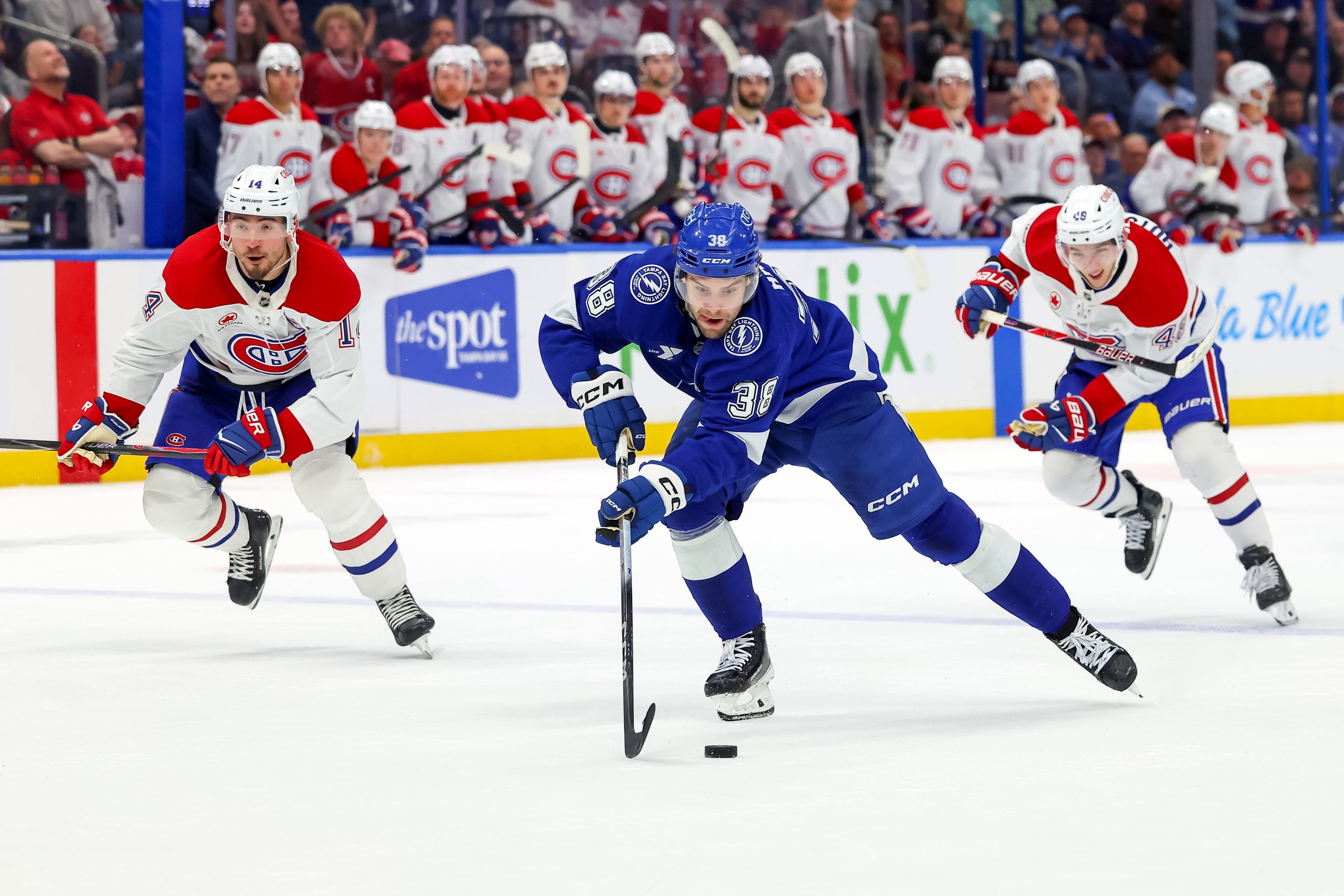 Brandon Hagel #38 of the Tampa Bay Lightning skates past two Canadiens players on a breakaway