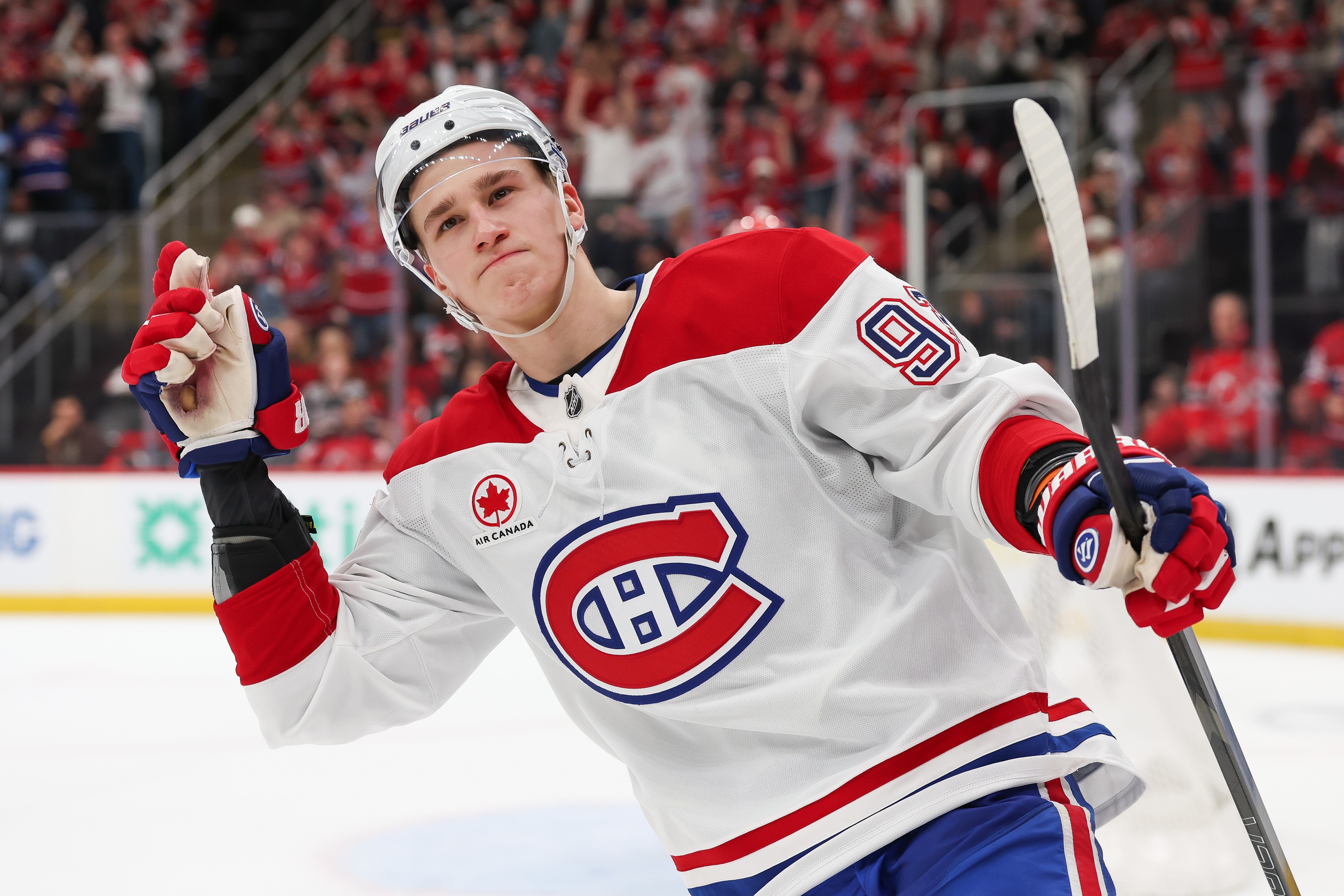 Hockey player signals to the fans after scoring a goal.