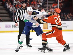 Curtis Douglas fights Jeffrey Viel #28 of the Anaheim Ducks during the first period