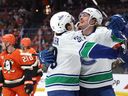 Ty Mueller #39 congratulates Curtis Douglas #42 of the Vancouver Canucks after his first career NHL goal during the first period against the Anaheim Ducks at Honda Center on April 12, 2026 in Anaheim, California. The Canucks won 4-3 in overtime.
