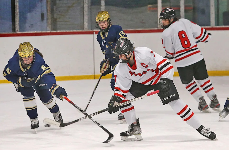 Bishops #18 Kendyl Nolan breaks up a play by Harborwomen captain Caroline Doherty.
Hingham girls hockey hosted Archbishop Williams at Pilgrim Arena on Wednesday Jan. 10, 2024