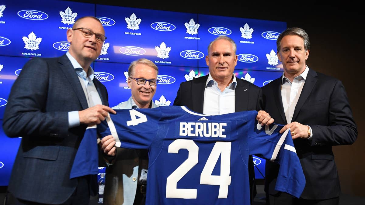 Maple Leafs head coach Craig Berube poses with a team jersey alongside former general manager Brad Treliving.Dan Hamilton-USA TODAY Sports via Imagn Images