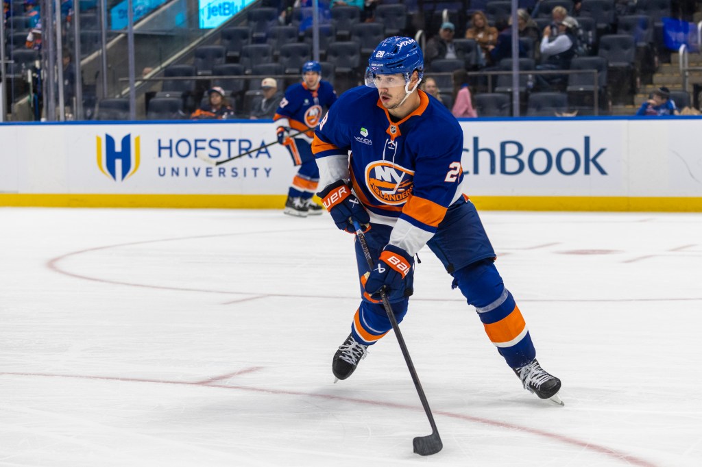 Alexander Romanov #28 of the New York Islanders moves the puck down ice during the second period at UBS Arena, Monday, Oct. 13, 2025, in Elmont, NY. 