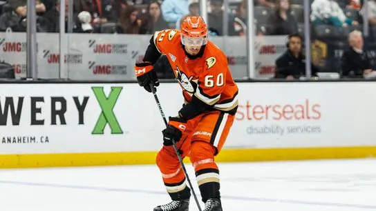 Anaheim Ducks defensemen Tyson Hinds (60) handles the puck during an NHL hockey game against the Calgary Flames, Saturday April 4, 2026 in Anaheim, Calif.