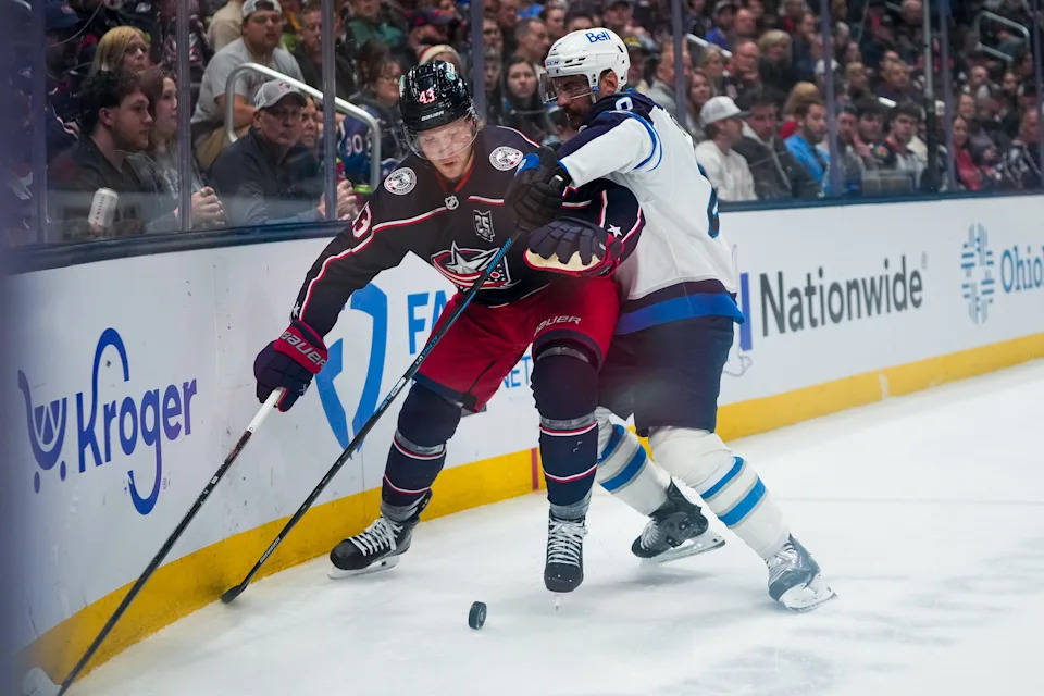 Columbus Blue Jackets left wing Danton Heinen (43) fights for the puck against Winnipeg Jets defenseman Dylan DeMelo (2) in the first period of the NHL game at Nationwide Arena on Saturday, April 4, 2026 in Columbus, Ohio.