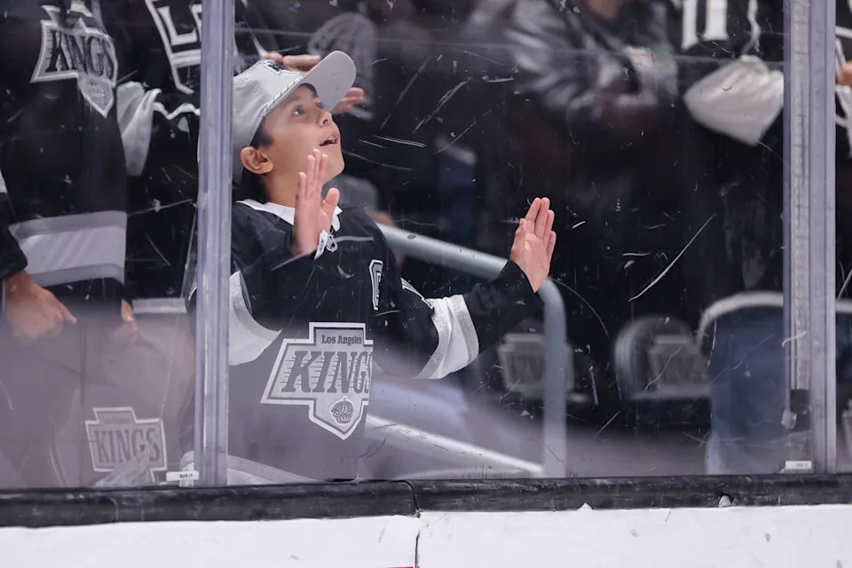 A young Los Angeles Kings fan looks on during an NHL hockey game against the Nashville Predators, Thursday April 2, 2026 in Los Angeles, Calif.