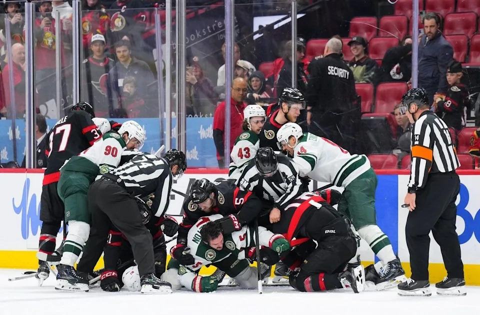  A short-lived scrum occurs between the Senators and the Wild at the end of the third period of Saturday’s game.