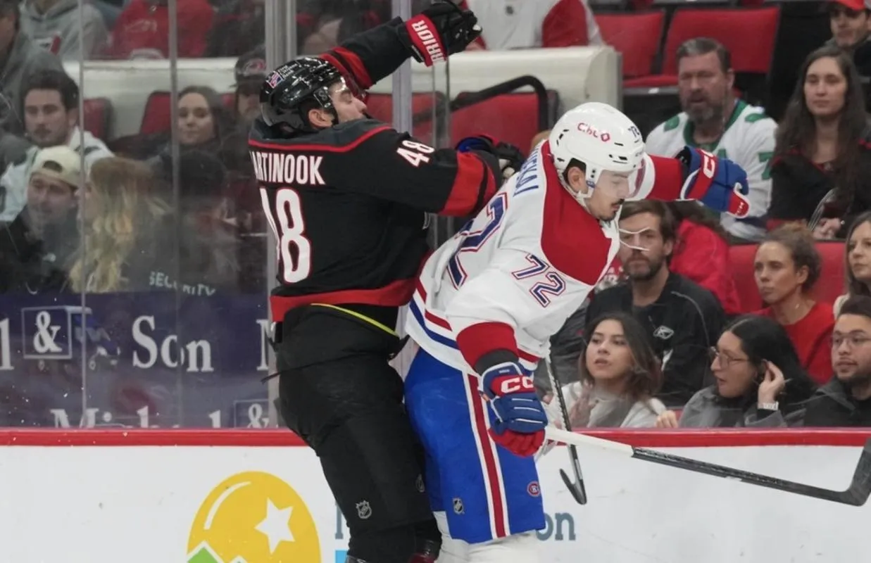 Montréal Canadiens defenseman Arber Xhekaj (72) checks Carolina Hurricanes left wing Jordan Martinook (48) at Lenovo Center.