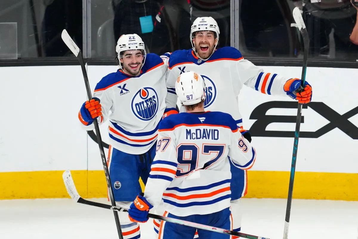 Edmonton Oilers defenseman Evan Bouchard (2) celebrates with center Matt Savoie (22) and center Connor McDavid (97) after scoring a goal during an overtime period to give the Oilers a 4-3 victory over the Vegas Golden Knights at T-Mobile Arena.