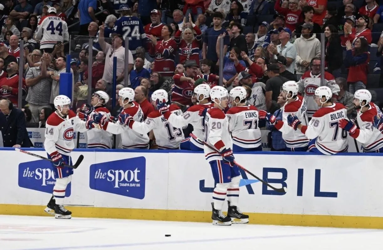 Montreal Canadian left wing Juraj Slafkovsky (20) celebrates with his teammates after scoring a goal in the first period against the Tampa Bay Lightning at Benchmark International Arena.