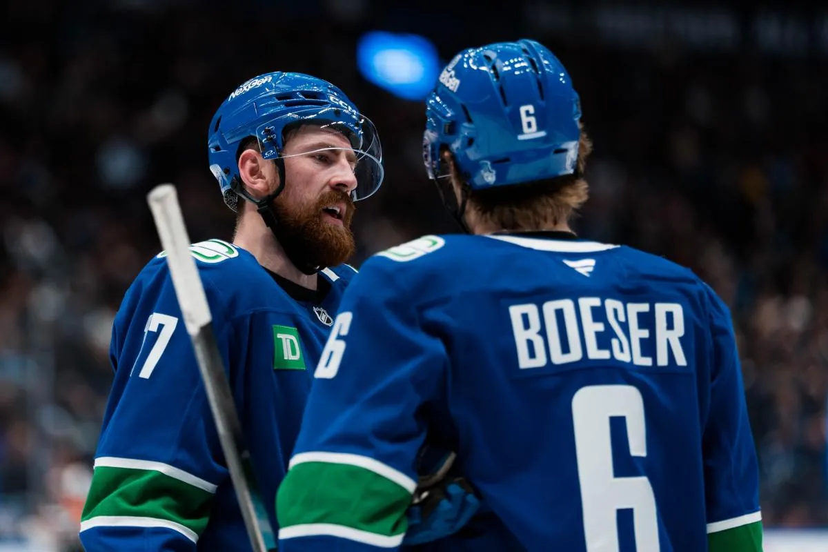 Vancouver Canucks defenseman Filip Hronek (17) talks with forward Brock Boeser (6) during a stop in play against the Los Angeles Kings in the second period at Rogers Arena.